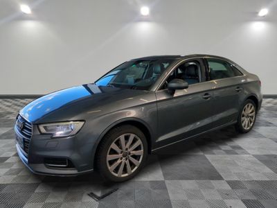 L'Audi est garée dans une grande pièce au sol carrelé en damier.