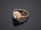 an image of a gold ring with a white diamond
