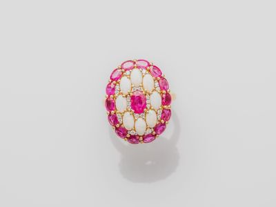 a pink and white stone ring with gold accents