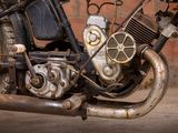 a close up of a motorcycle engine with a brick wall in the background