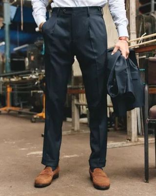 a man that is wearing a tie and suspenders