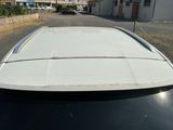 a white car parked on the side of the road