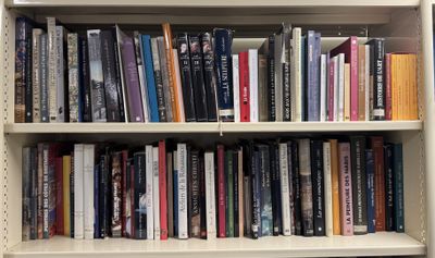 a book shelf with many books on it in a library
