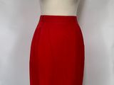 red skirt on a mannequin stand against a white backdrop