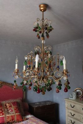 a chandelier hanging from the ceiling in a bedroom
