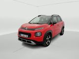 a red citrole is parked in a white room