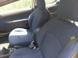 a picture of a car with blue seats and a black seat belt