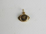 a gold plated eye charm with the word ' i love you ' written on it