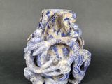 a blue and white vase with a snake on it