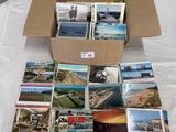 a lot of postcards in a box on a table