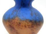 an image of a blue and gold vase on a white background