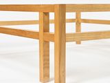 underside view of a wooden bed frame against a white background