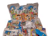 many bags of toys on a bed with a white background