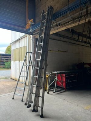 two ladders that are leaning up against the wall