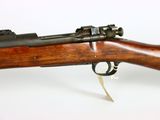 an old rifle with a wooden barrel on a white background