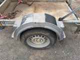 a trailer with a trailer attached to it in the dirt