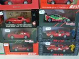 four red toy cars in the boxes on the table