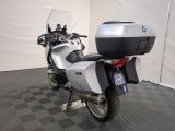 a motorcycle that is parked in a room with a checkered floor