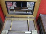 a small wooden table with a mirror on top of it