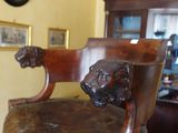 a chair with a lion head on it in a living room