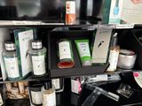 a shelf with a lot of bottles and containers on it