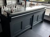 a bar with bottles of alcohol on it in a restaurant