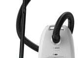 a close up of a vacuum and a canister on a white background