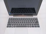 a laptop computer sitting on a table with a keyboard on it
