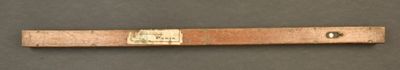 a wooden ruler that is on a table
