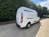 the white van is parked on the side of the road