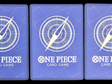 three blue playing cards with one piece and one piece logo on them