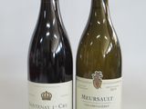 two bottles of wine sitting next to each other on a table