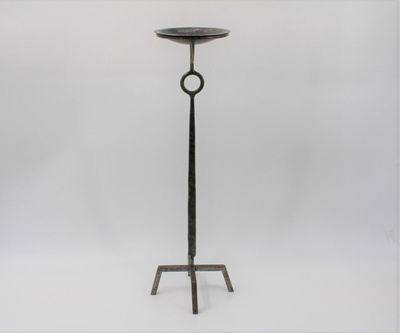 a black iron candle stand with a circular ring on top
