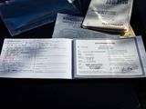 a passport, a passport book, and a ticket sitting on a table