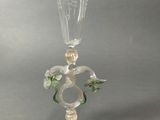 a glass vase with flowers on it on a table