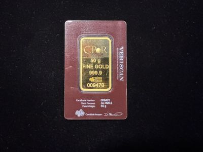 un gros plan d'un lingot d'or posé sur une surface noire