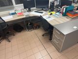an image of a desk with two computer monitors and a file cabinet