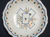 a white plate with blue and orange designs on it