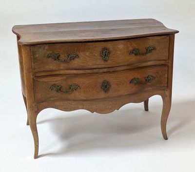 a small wooden chest of drawers on a white background