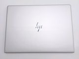 the back of a laptop computer sitting on top of a white table