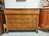 a dresser with a lamp on top of it in a room