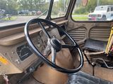a steering wheel and a seat in this old truck