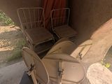 two chairs and a toilet in the corner of a room