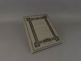 a white book with a blue border sitting on top of a table