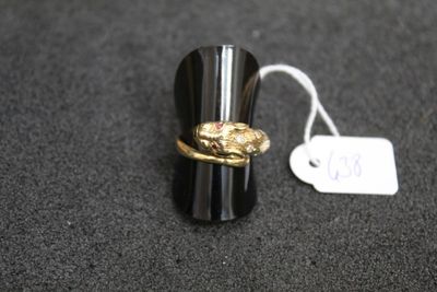 a ring with a snake on it sitting on a table