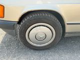 a close up of a car ' s tire on a gravel road