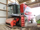 a large red combiner that is parked in a building