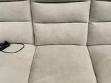 a couch with a remote control on it in a living room