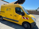 a yellow van parked in a parking lot with a crane on top of it