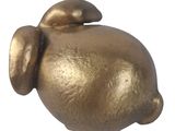 a gold pig figurine sitting on a white surface